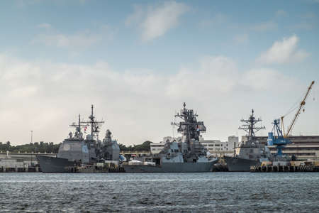 Oahu, Hawaii, USA. - January 10, 2020: Pearl Harbor. Gray USS Decatur and Chafee destroyers together with other war ships in port on dark bue gray water under light blue cloudscape.のeditorial素材