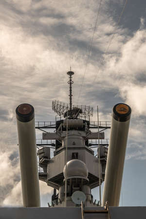 Oahu, Hawaii, USA. - January 10, 2020: Pearl Harbor. Closeup of 2 heavy guns with tower in between of USS Missouri Battle Ship under white-blue cloudscape.のeditorial素材