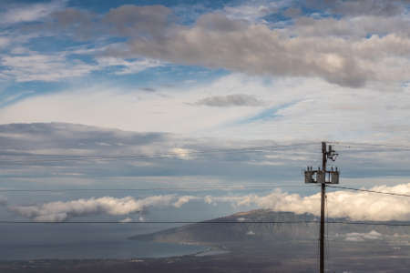 Kahului, Maui,, Hawaii, USA. - January 13, 2020: Different layers of clouds in blue sky over land...