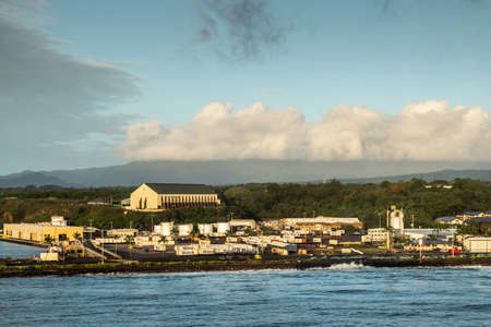 Nawiliwili, Kauai, Hawaii, USA. - January 16, 2020: Early morning light on Matson container yard in port with large self-storage buidling on hill top under light blue cloudscape.のeditorial素材