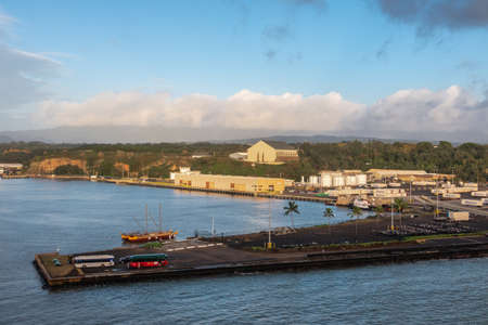 Nawiliwili, Kauai, Hawaii, USA. - January 16, 2020: Early morning light on the docks in the port with Matson container yard and Guardian Self Storage warehouse on hill under light blue cloudscape.のeditorial素材