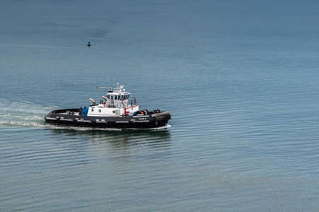 Hilo, Hawaii, USA. - January 9, 2012: Closeup of Black and white Tiger 6 tugboat in harbor, surrounded by blue water.のeditorial素材