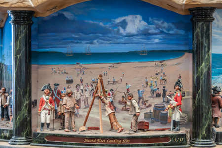 Sydney, Australia - December 11, 2009: Inside Queen Victoria building shopping mall. Closeup of Second-fleet-landing painting and puppets set in giant clock contraption. Blue sky, beige sand, and people.のeditorial素材