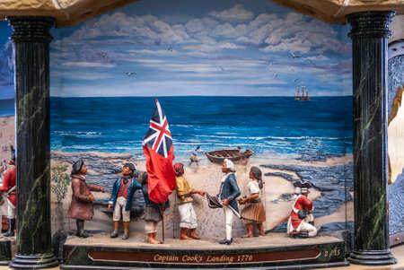 Sydney, Australia - December 11, 2009: Inside Queen Victoria building shopping mall. Closeup of Captain-Cook-landing painting and puppets set in giant clock contraption. Blue sky, beige sand, and people.のeditorial素材