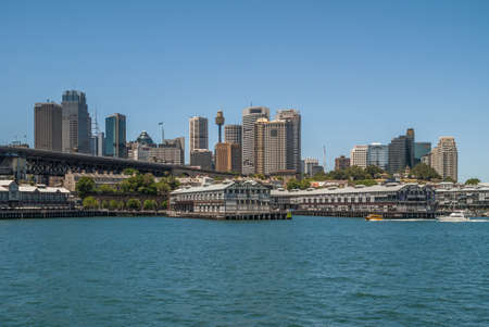 Sydney, Australia - December 11, 2009: Historic piers now converted into housing and offices at Dawes Point under blue sky. Downtown skyline and on-ramp to Harbour bridge.のeditorial素材