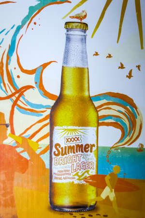 Brisbane, Australia - December 8, 2009: Castlemaine Perkins brewery. Closeup of poster promoting XXXX Summer Bright Lager with beach theme.のeditorial素材