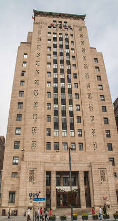 Shanghai, China - May 4, 2010: Brown stone building of Bank of China along the Bund with pedestrians...