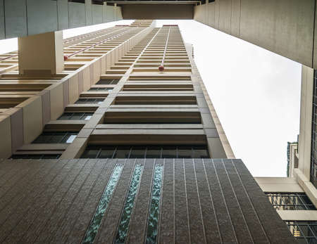 Shanghai, Pudong, Lujiazui, China - May 4, 2010: fish eye shot between walls of skyscraper creates composition of beige and brown squares and rectangulars with some silver sky.のeditorial素材