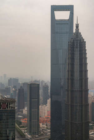 Shanghai, Pudong, Lujiazui, China - May 4, 2010: Closeup of World Financial Center and Jinmao skyscrapers with more towers in background under thick smog, locally jokingly known as sandstorms.のeditorial素材
