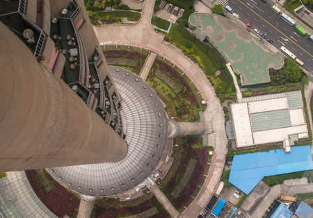 Shanghai, Pudong, Lujiazui, China - May 4, 2010: Looking straight down along shaft from panorama deck of Oriental Pearl TV Tower. Green and white and blue roofs.のeditorial素材
