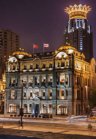 Shanghai, China - May 4, 2010: Night portrait of colorfully lighted historic Bangkok Bank building on the Bund with crowned top of Financial Center in back.のeditorial素材