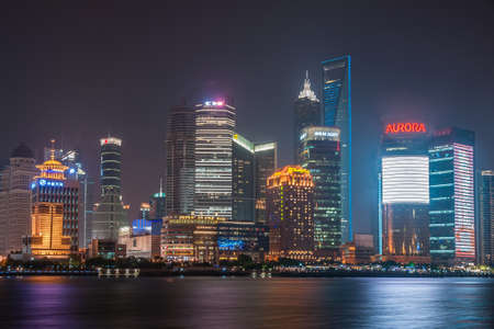 Shanghai, Pudong, Lujiazui, China - May 4, 2010: Night skyline of colorfully lighted skyscrapers around Shangri-la hotel across Huangpu river, as seen from the Bund.のeditorial素材