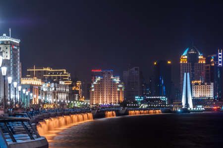 Shanghai, China - May 4, 2010: Night  photo of The Bund boardwalk along Huangpu River ending at Waibaidu bridge over Wusong river. Skyline with colorfully lighted highrise buildings.のeditorial素材