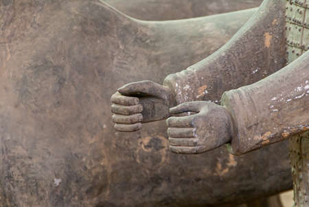 Xian, China - May 1, 2010: Terracotta Army excavation site. Closeup of 2 beige-gray human hands....
