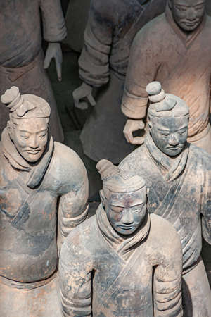 Xian, China - May 1, 2010: Terracotta Army museum and hall. 3 gray-beige ancient soldier sculptures at excavation.のeditorial素材
