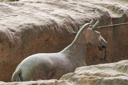 Xian, China - May 1, 2010: Terracotta Army museum and hall.  Gray-beige ancient horse sculpture at excavation.のeditorial素材