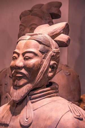 Xian, China - May 1, 2010: Terracotta Army museuml.  Side Closeup of reddish bearded head of officer sculpture with another one in faded back.のeditorial素材