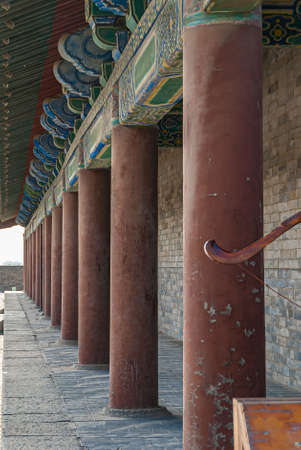 Xian, China - April 30, 2010: North Gate of Huancheng City Wall. Pillar wall and colorful decorated beams at palace above gate. Gray tiled surface.のeditorial素材