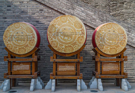 Xian, China - April 30, 2010: North Gate of Huancheng City Wall. 3 war drums on display at gate with historic explanation texts.のeditorial素材