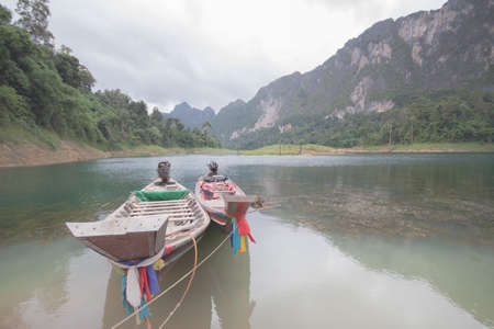Two wooden boats lie on the sea in Thailand