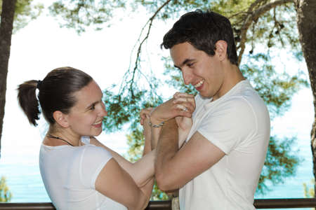 Young cute couple connected with their hands in love