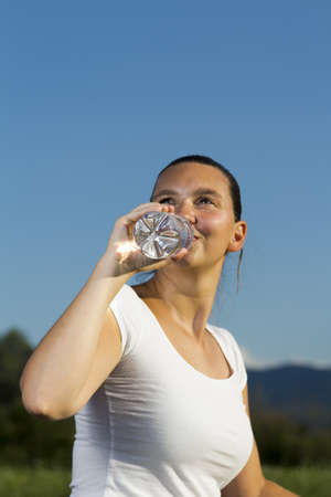 A young sportive girl with a bottle
