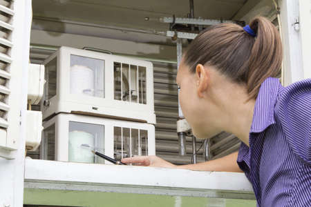 Young woman meteorologist reading meteo instruments