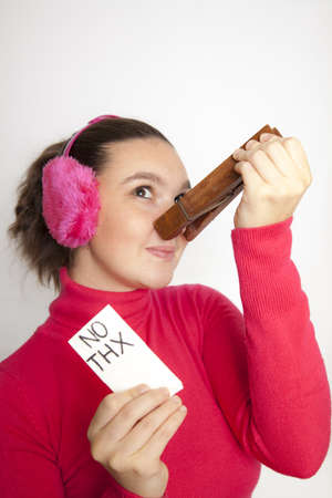 Cute young woman with giant clothespin on her nose, do not want to use handkerchief any moreの写真素材
