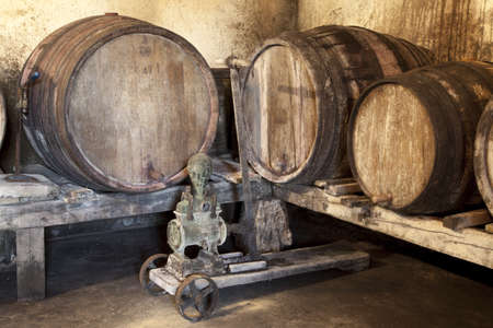 Interior of very old wine cellar with vintage wine pumpの写真素材