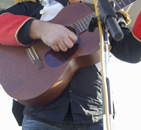 Acoustic guitar guitarist playing on stage, selective focus on guitar