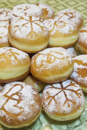 Sweet fresh baked donuts sprinkled with powdered sugar on a glass plate,   close upの写真素材