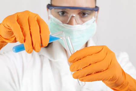 Medical or scientific researcher- chemist- scientist using test tubes-epruvetes  in a laboratory-...
