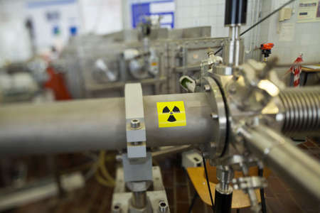 View of important electronic and mechanical parts of ION Accelerator, with high radiation warning  sign, CNC machined parts, selective focusの写真素材