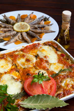Melanzane alla Parmigiana and Marinated sardines in background