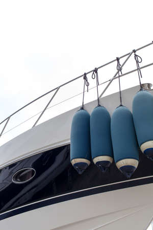 Big inflatable fenders on luxury yacht, space for textの写真素材