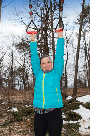 Young athletic fitness woman working out at outdoor gym