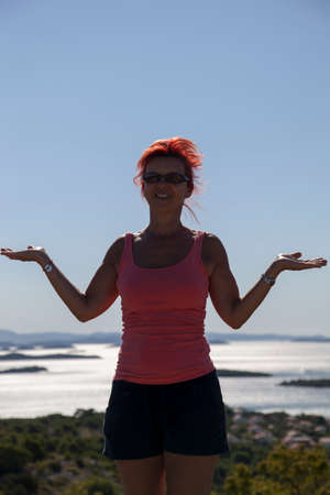 Pretty woman, silhouette, enyojing, excercising on sea coast in Kornati national park, paradise islands, archipelago in Dalmatia, Croatia, space for textの写真素材