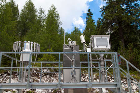 Modern Meteo Scientific weather station high in the mountains, against cloudy blue sky