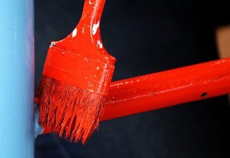 brush painting red on steel bar