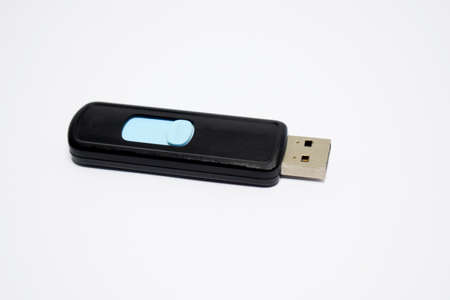 A blue and black colored pen drive placed on a white isolated background