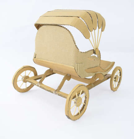Back view of a brown colored carriage made of recycled card-board displayed on an isolated white backgroundの写真素材
