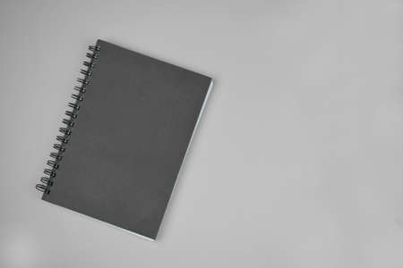 Black and white photograph of a simple writing diary over a simple paper background