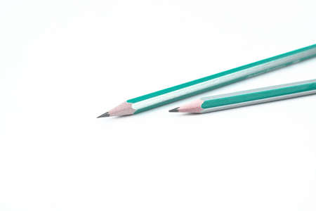Two white and blue colored wood pencil crayon placed on an isolated white paper background