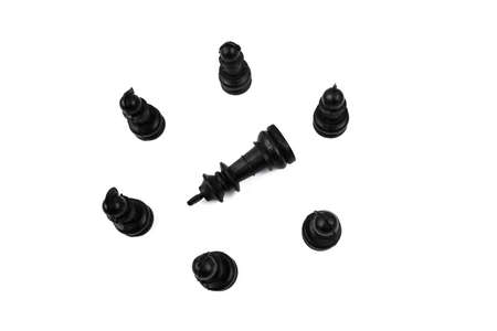 The black king placed in the middle of six different black pawns making a round circleの写真素材