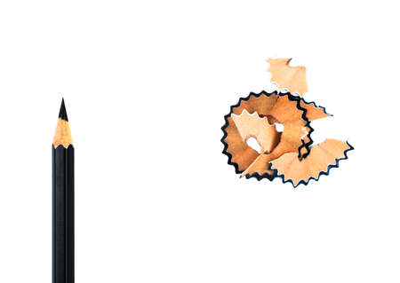 Top view of some pencil shavings placed beside a black color wood pencil crayonの写真素材