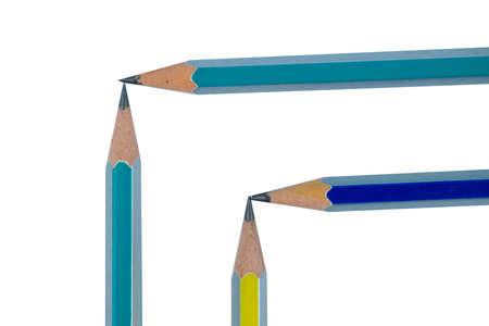 Four various colored wood pencil crayon making two corner on two different squares