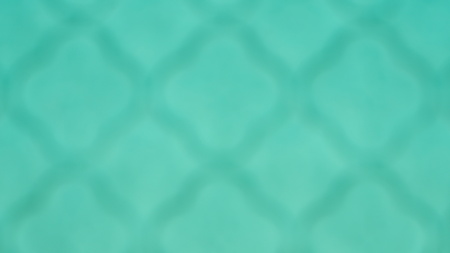 Blurred unfocused dark grid on bright turquoise background. Abstract turquoise colored gradient art geometric background.の写真素材