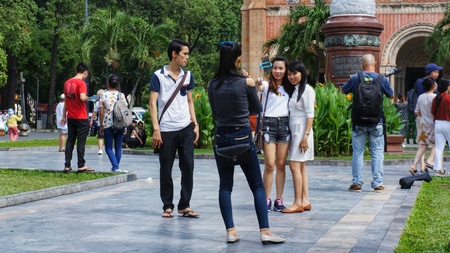 Ho-Chi-Minh-City (former Saigon), Vietnam, 22nd July 2016. Unidentified young people taking photos of each other in parkin front of statue.のeditorial素材