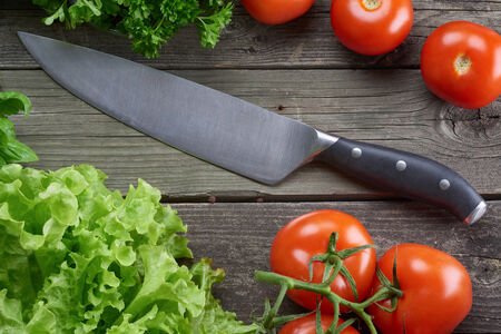 Kitchen knife on old rustic wooden tableの写真素材