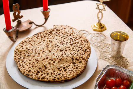 Handmade shmura matzah on a plate on the seder pesach table.の写真素材